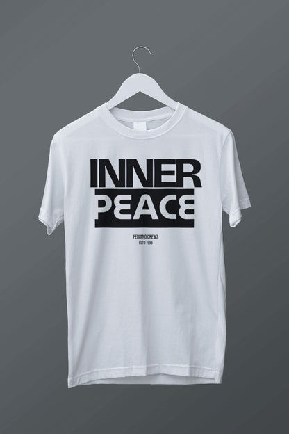 White t-shirt with 'INNER PEACE' text on a hanger against a dark background